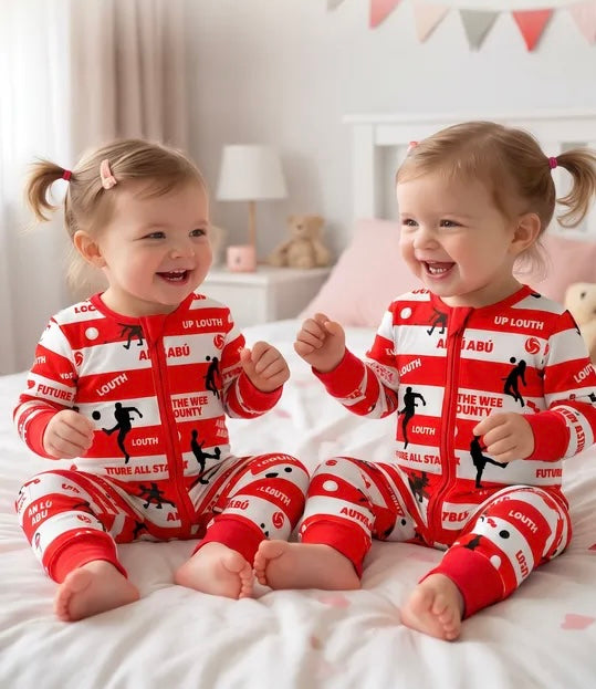 Smiling toddler wearing a farm zipped sleepsuit
